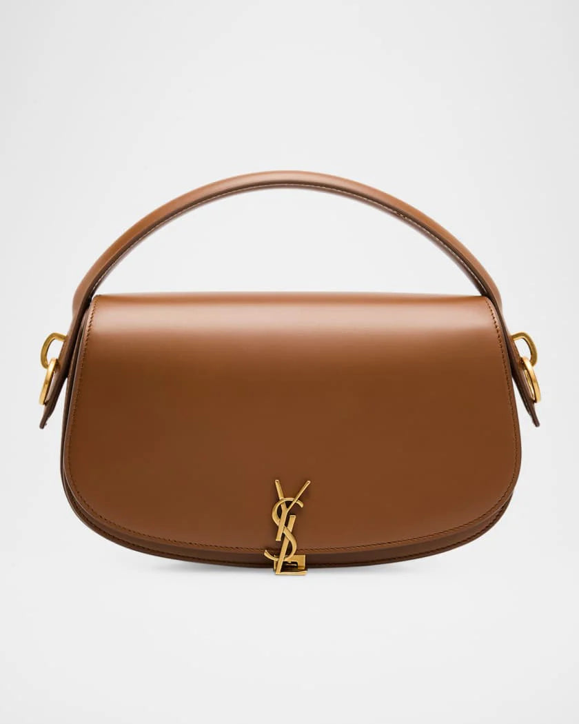 Brown handbag with gold accents on a light gray background