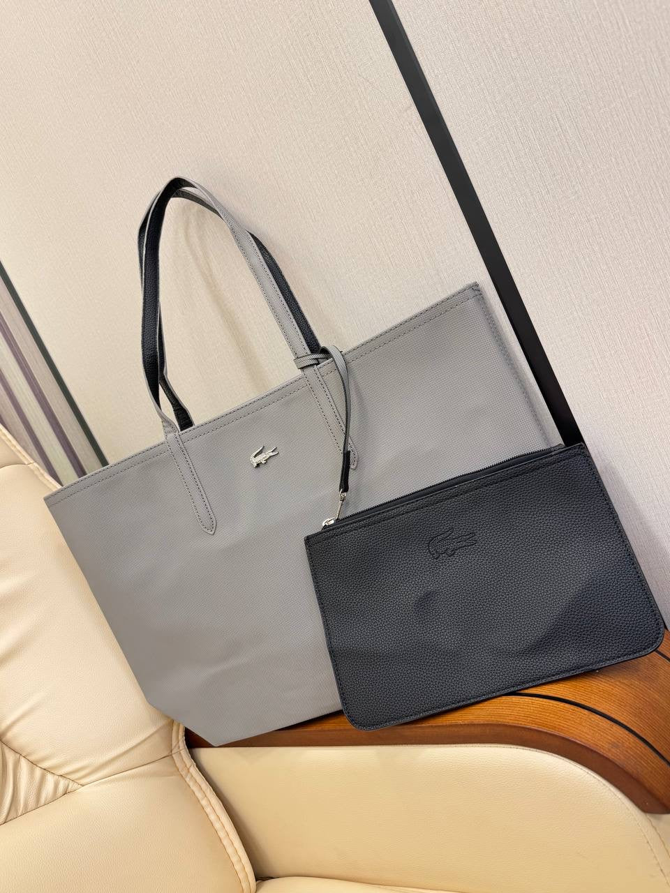 Gray and black handbags with a visible brand logo on a light background