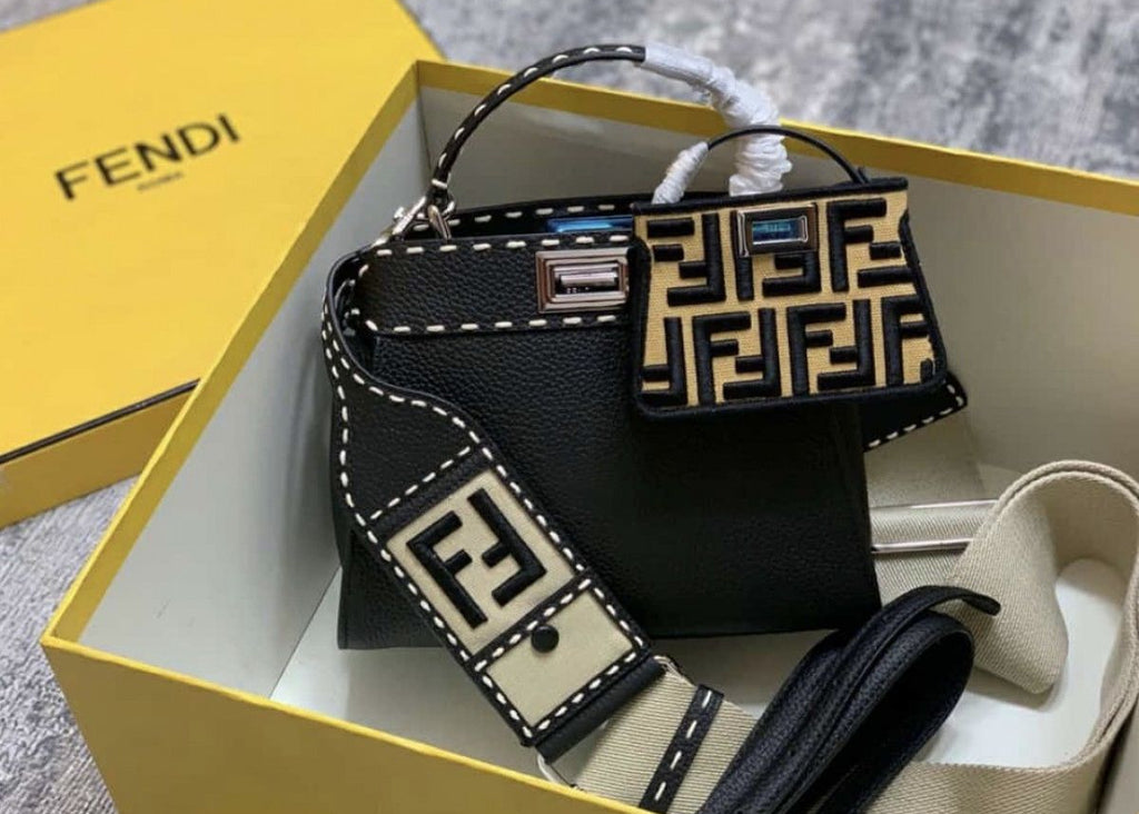 Fendi handbag with matching strap in an open yellow Fendi box.
